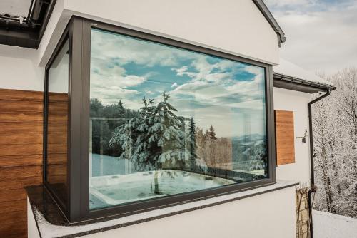 a window with a view of a snow covered tree at KROSNA92 in Krosna