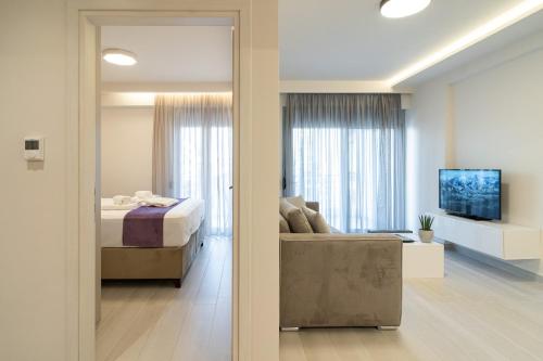 a bedroom with a bed and a living room at Petit Palace Trikala in Tríkala