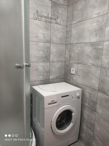 a laundry room with a washing machine in it at Апартаменти центр біля озера in Ternopilʼ