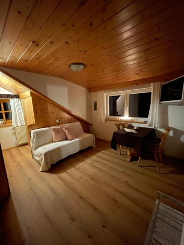 salon z łóżkiem, stołem i oknami w obiekcie Fesengut w mieście Annaberg im Lammertal