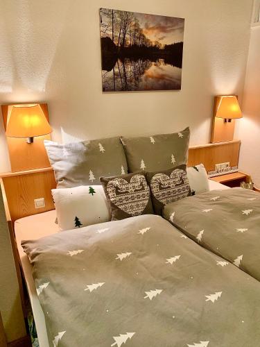a bedroom with two beds with pillows with stars on them at FeWo Fuchs Saig in Lenzkirch
