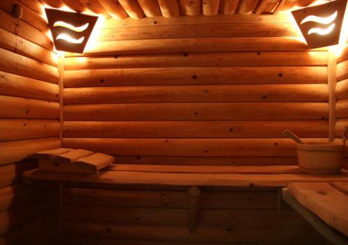 a sauna with two lights on a wooden wall at DW Pod Jaworami - relaks w SPA - jacuzzi, sauna na wyłączność in Białka Tatrzańska