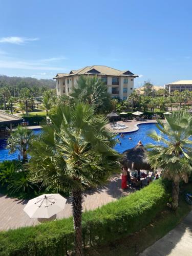 an overhead view of a resort pool with palm trees at Vg Sun cumbuco 310 c4 in Cumbuco