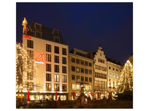 a group of buildings with christmas lights and a christmas tree at Eden Hotel Früh am Dom in Cologne