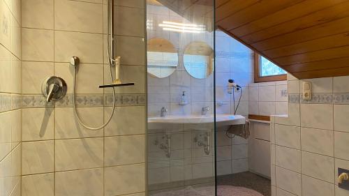 a bathroom with a shower and a sink at Ferienwohnungen Flörl in Zell am Ziller