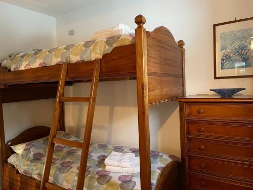 a bedroom with a bunk bed with a dresser at La finestra sul Matese in San Massimo