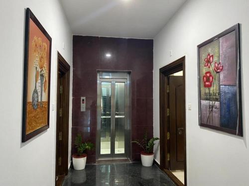 a hallway with paintings on the walls of a building at OM SRINIVASA - TRULY HOMESTAY in Tirupati