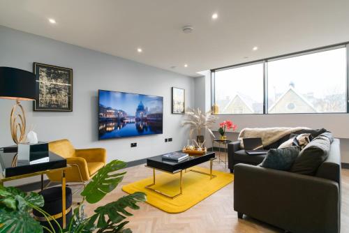 a living room with a couch and a table at Luxe Apartments, The Moorwell, Secure Parking, - 10mins Cardiff City Ctr in Cardiff