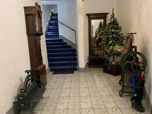 a hallway with a blue staircase with a christmas tree at NB Apartments Riga Old Town in Riga