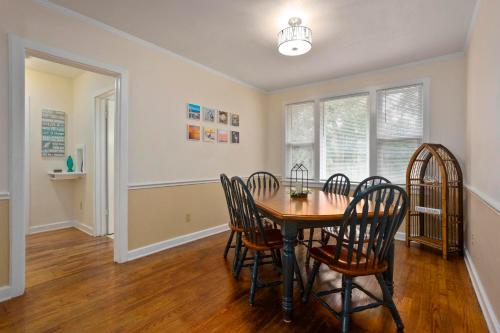 a dining room with a table and chairs at Dolphina House Pensacola in Pensacola