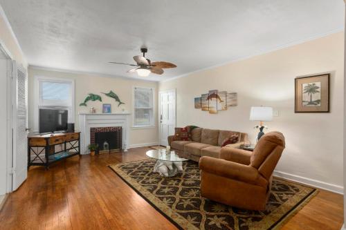a living room with a couch and a fireplace at Dolphina House Pensacola in Pensacola
