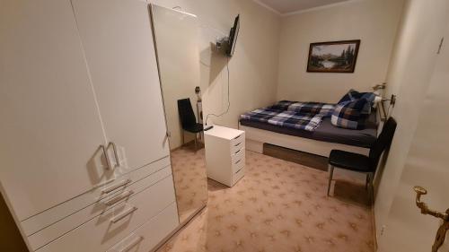 a small room with a bed and a chair in it at Ferienwohnung Bonese in Bonese