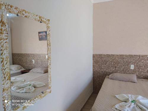 Postel nebo postele na pokoji v ubytování Raízes Hotel