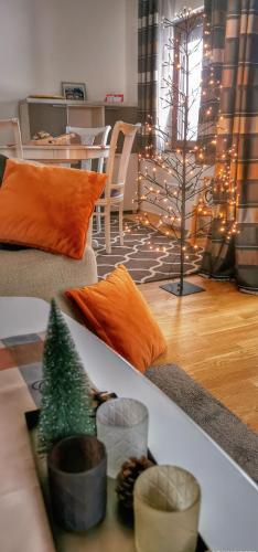a living room with a couch with a christmas tree on it at Vikendica Gradina Zlatibor in Čajetina
