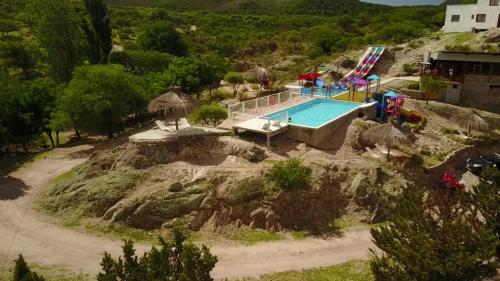 una vista aérea de una piscina en una montaña en Cabañas y Toboganes Rancho la Ñata en Mina Clavero