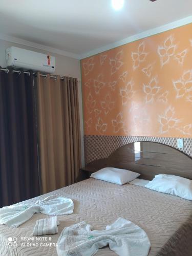 Postel nebo postele na pokoji v ubytování Raízes Hotel