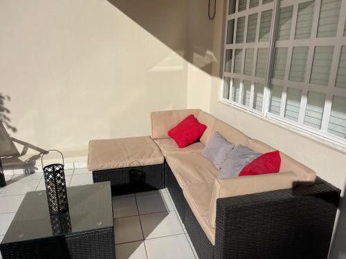 a living room with a couch and two red pillows at Otay Studio great patio near Otay Crossing & Airport in Tijuana