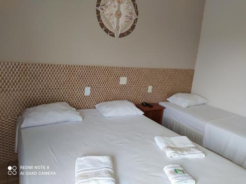 Postel nebo postele na pokoji v ubytování Raízes Hotel