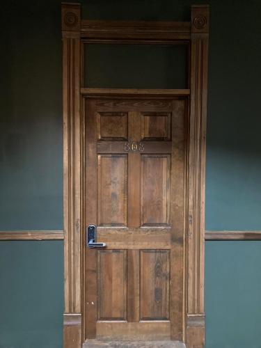 a wooden door with a handle on it at Grand Central Hotel in Eureka Springs