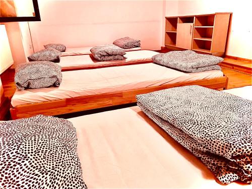 a room with three beds in a room at A.G ROMANA HOSTEL in Bucharest