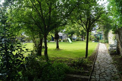 a park with trees and a playground in the background at Normand'Histoire Gite 1869 in Isigny-sur-Mer