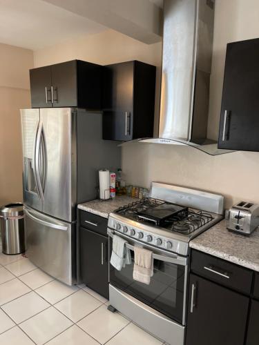 a kitchen with a stove and a refrigerator at Otay Studio great patio near Otay Crossing & Airport in Tijuana