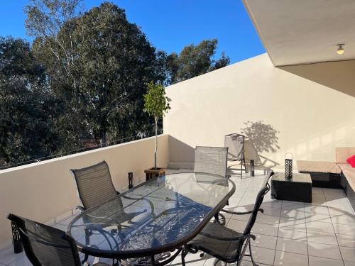 a patio with chairs and a glass table at Otay Studio great patio near Otay Crossing & Airport in Tijuana