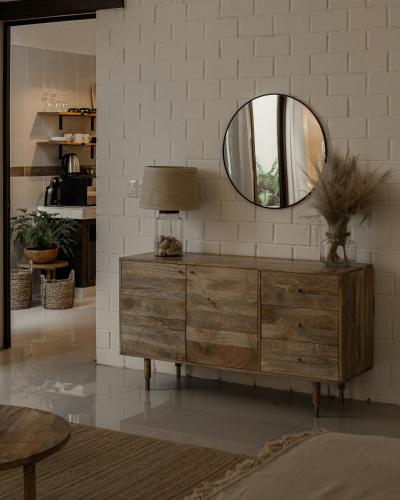 a mirror on top of a dresser in a living room at Narrativ Lofts - Serena - Beautiful Colonial Suite in Campeche