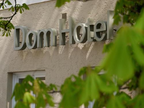 a sign on the side of a building at Dom Hotel in Augsburg