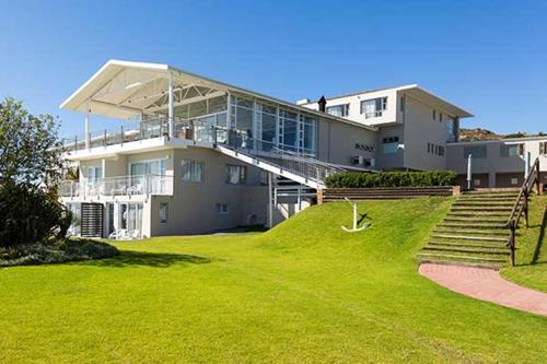 a large house with a lawn in front of it at Saldanha Bay Hotel in Saldanha