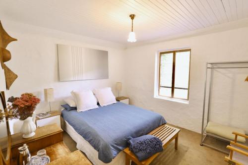 a bedroom with a bed and a window at The Snug in Robe