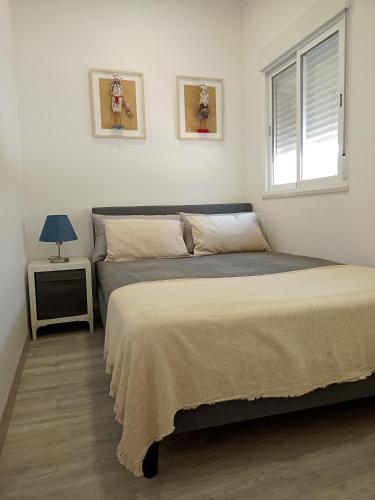a bedroom with two beds and a window at A Casa da Mila - Beach House in Costa da Caparica
