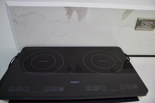 a microwave oven sitting on top of a counter at Shark Town Mal Pais in Santa Teresa Beach