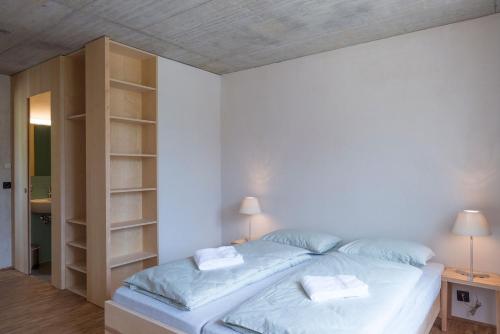a bedroom with a bed and a book shelf at Saanen Gstaad Youth Hostel in Gstaad