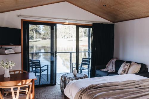 a bedroom with a bed and a balcony at Worrowing Jervis Bay in Huskisson