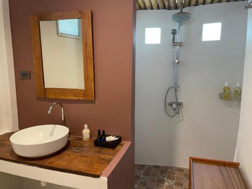 a bathroom with a sink and a mirror on a counter at The Pace Phuket Boutique Resort in Rawai Beach