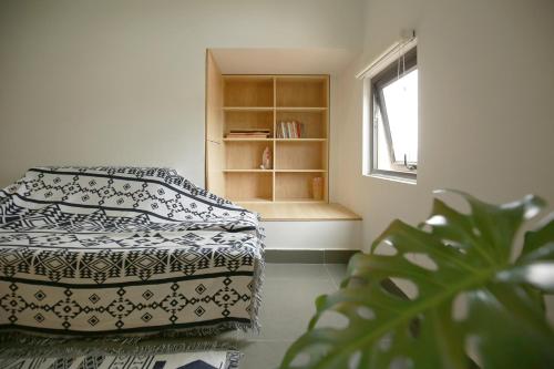 a bedroom with a bed and a book shelf at DaLaHa City in Da Lat