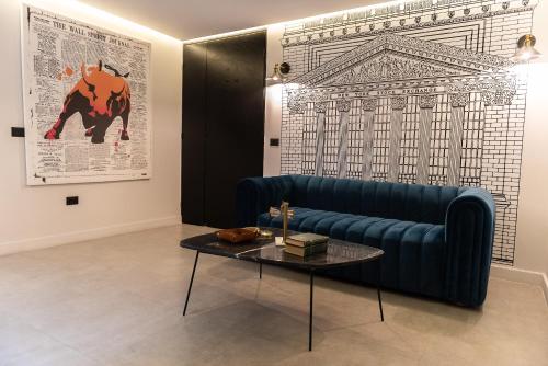 a living room with a blue couch and a table at FULTON Business Luxury HOTEL in Guadalajara
