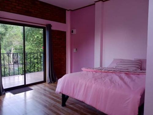 a bedroom with a bed and a large window at หลับสบายที่ดอยตุง Zuh meh ja Home lodge in Ban Pa Kluai La Hu