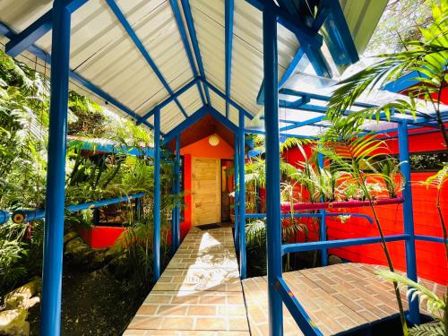 a building with blue beams and plants at El Sol Monteverde in Monteverde Costa Rica