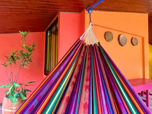a colorful hammock hanging in a room at El Sol Monteverde in Monteverde Costa Rica