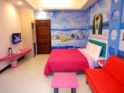 a bedroom with a red bed and surfboards on the wall at Ship House in Xiaoliuqiu