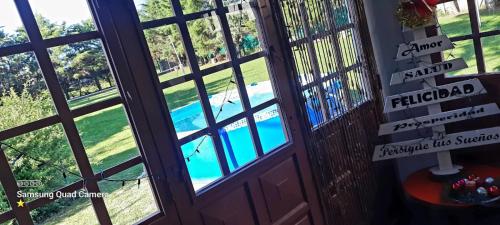 a door with a view of a swimming pool outside at Mendiolaza Tennis Park in Cordoba