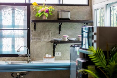 a kitchen with a sink and a counter top at Kerton Hostel in Lamai