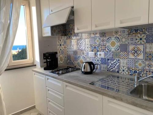 a kitchen with a tea kettle on the counter at B&B La Lingua in Procida