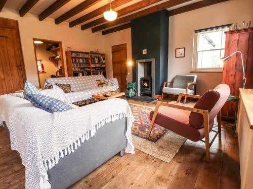 a living room with a couch and a table at Llysgwaun in Fishguard