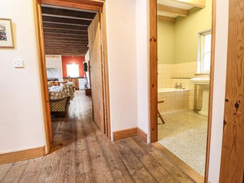 a hallway with a room with a bathroom and a tub at Llysgwaun in Fishguard