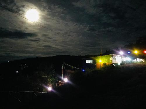 a train at night with the moon in the sky at Sunrise Point Homestay in Nagarkot