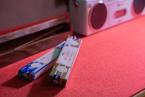 a pair of batteries sitting on top of a red table at Shourin Hotel Cheonan by Aank in Cheonan