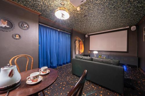 a room with a couch and a table and a screen at Shourin Hotel Cheonan by Aank in Cheonan
